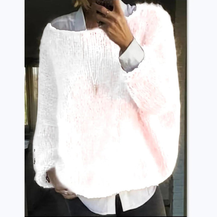 Model wearing a women's cozy knit long sleeve sweater with jeans, showcasing a casual winter outfit.