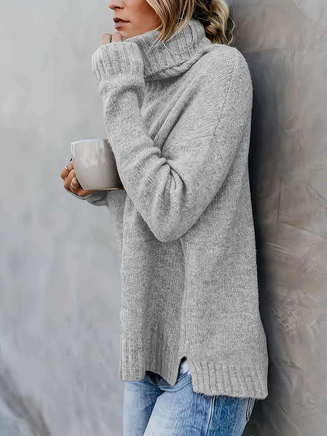 Long sleeve women's turtleneck sweater with a modern split hem for winter wear.
