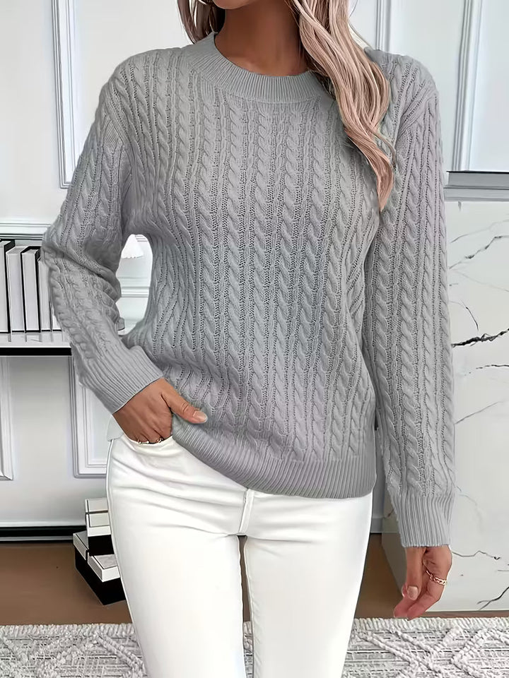 Soft knit women's crew neck sweater with cable patterns. Essential autumn layering piece for cozy style.