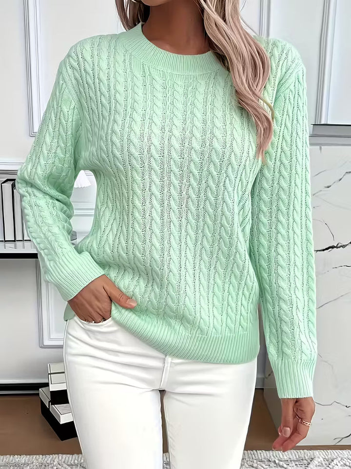Soft women's cable knit crew neck jumper in a rich texture. Perfect for autumn layering & casual wear.