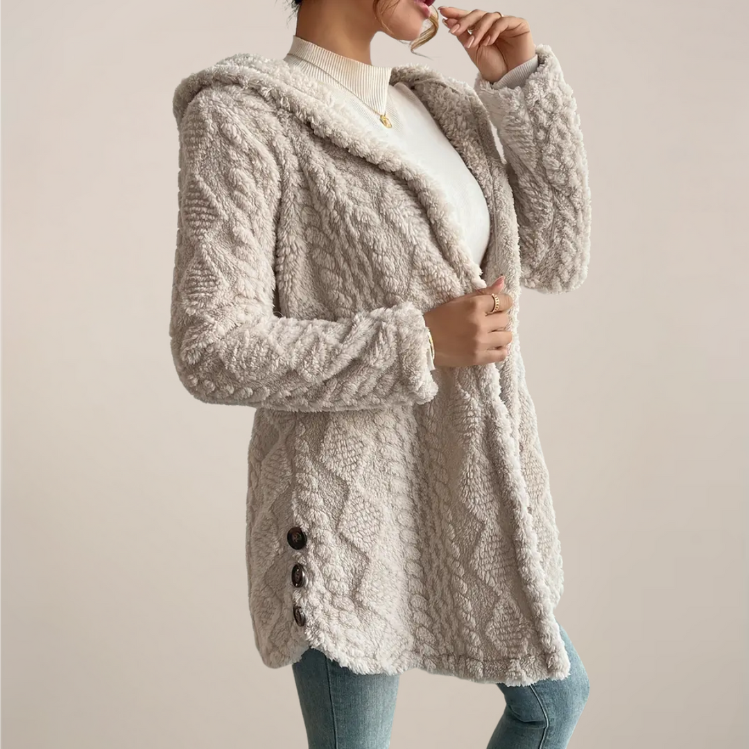 Close-up of soft textured knit fabric on a women's hooded cardigan, perfect for spring fashion