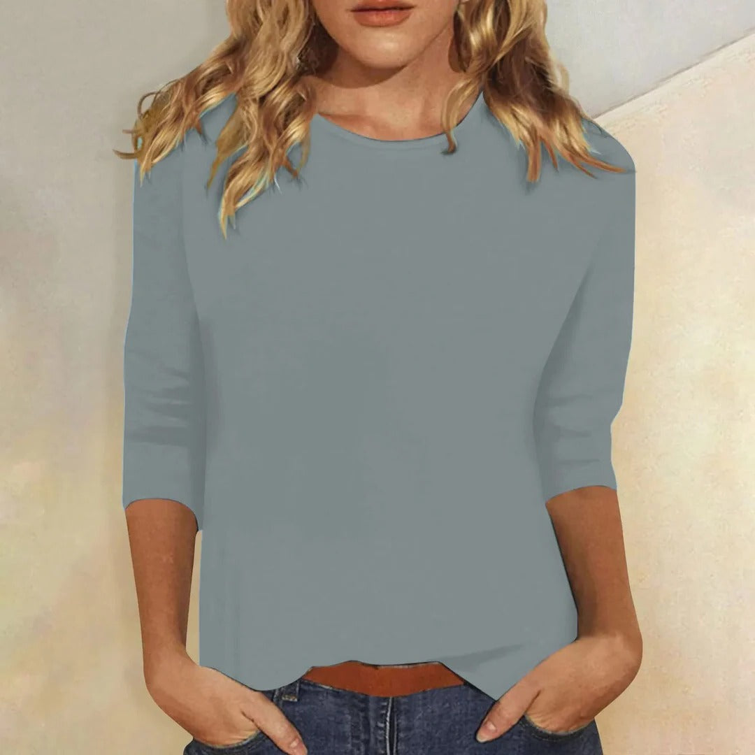 Relaxed fit women's top featuring a classic crew neck and 3/4 sleeves for casual comfort.