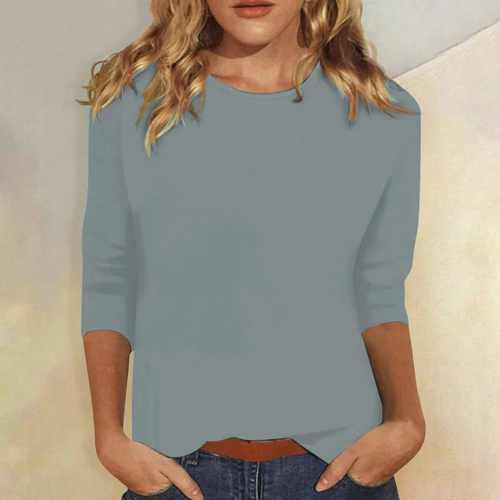 Relaxed fit women's top featuring a classic crew neck and 3/4 sleeves for casual comfort.