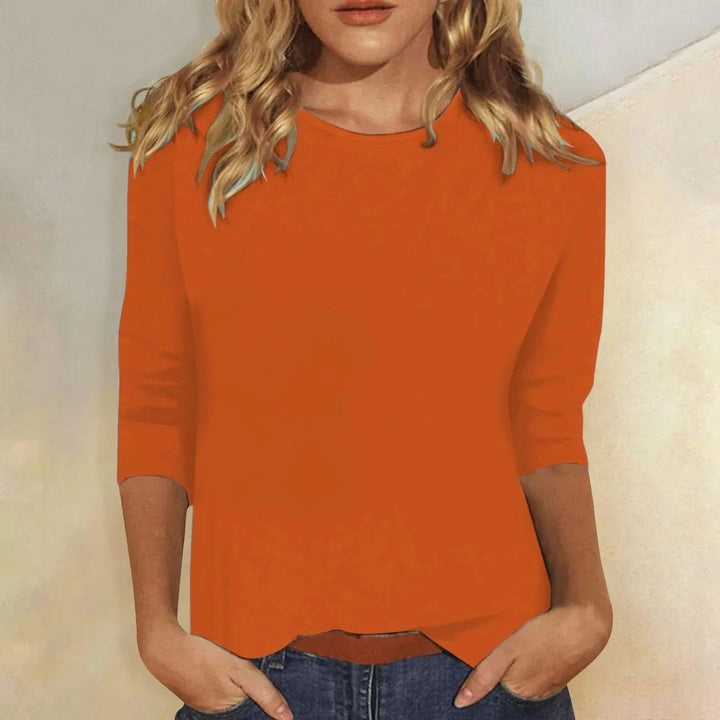 3/4 sleeve women's top with crew neck. Relaxed fit design offers comfortable and versatile style.