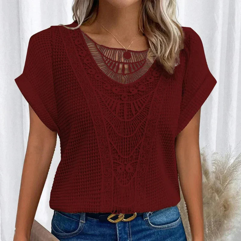 Ladies' fashion top: crochet-style blouse with elegant neck detail and comfortable short sleeves.