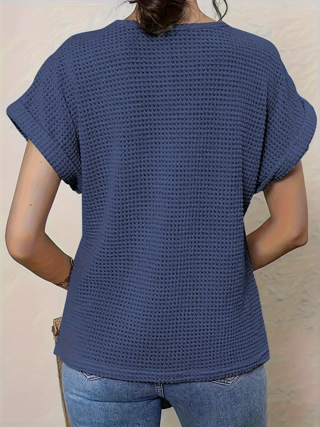 Elegant short sleeve crochet-style women's top, perfect for a chic spring or summer outfit.