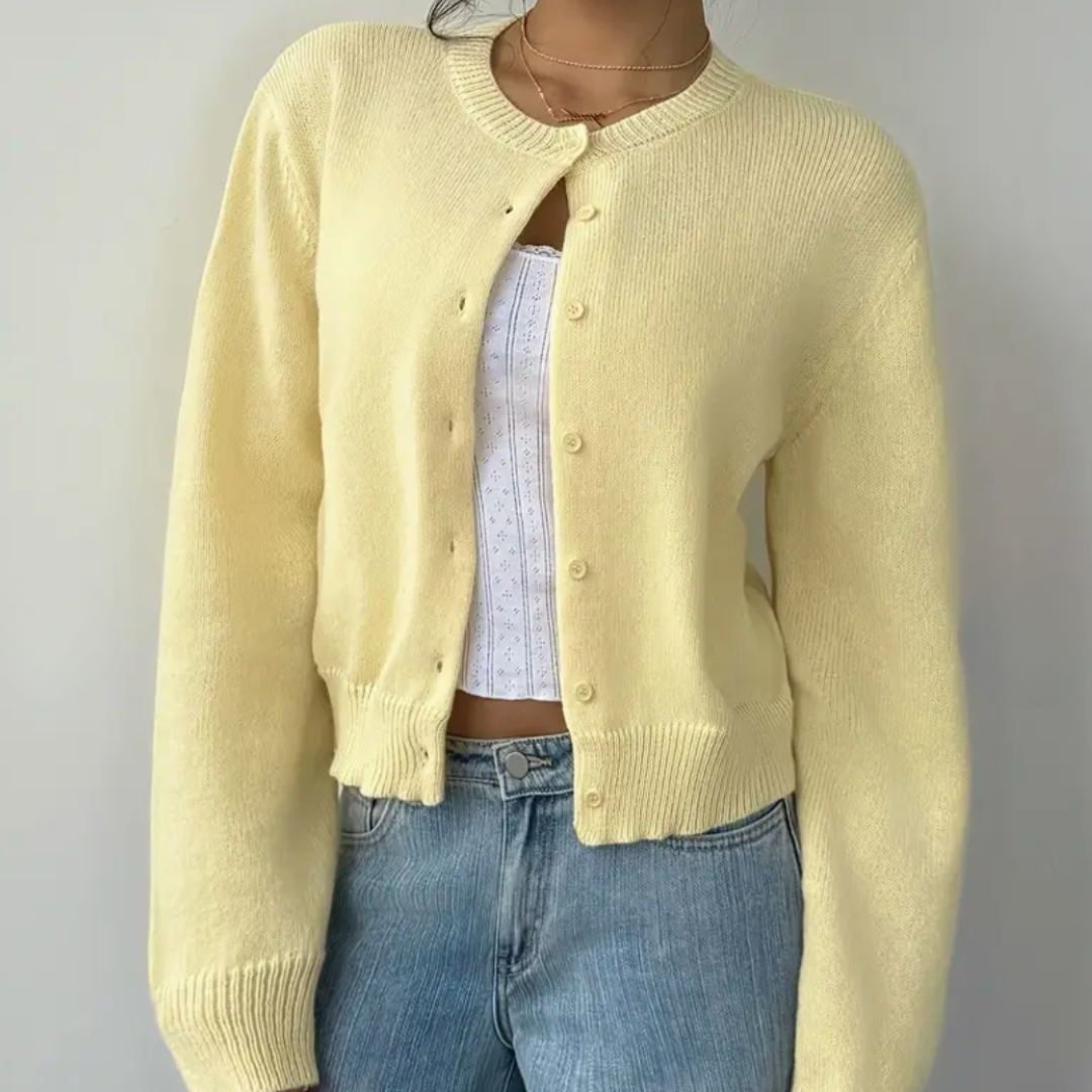 Close-up of buttons on a women's cropped knit cardigan, quality detail