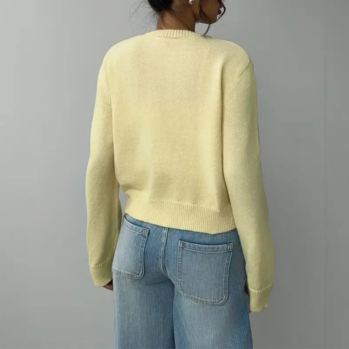 Soft knit women's cropped cardigan with elegant buttons, versatile piece