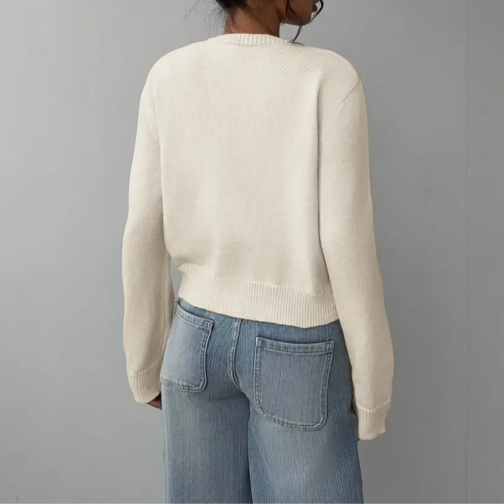 Model wearing a cropped knit cardigan with buttons, ideal for warmer weather