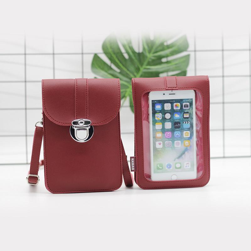 Lifestyle shot: Women's crossbody phone bag on a cafe table, ready for a day out