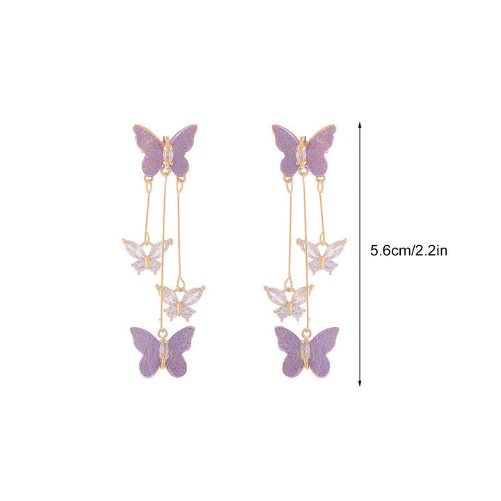 Detailed shot of a women's crystal butterfly earring, showing individual crystal placement and tassel