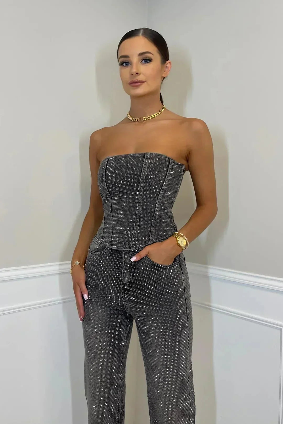 Women's stunning glitter crop top and high-waisted jeans, forming a trendy two-piece ensemble.