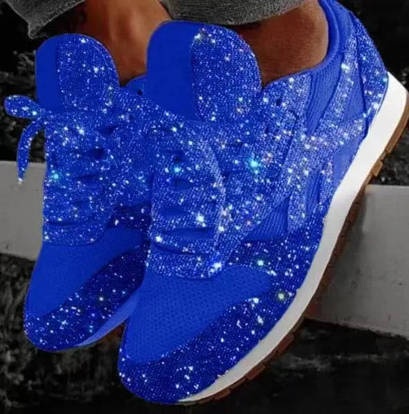 Side view of chic women's glitter lace-up sneakers. Trendy, dazzling casual footwear with white soles.