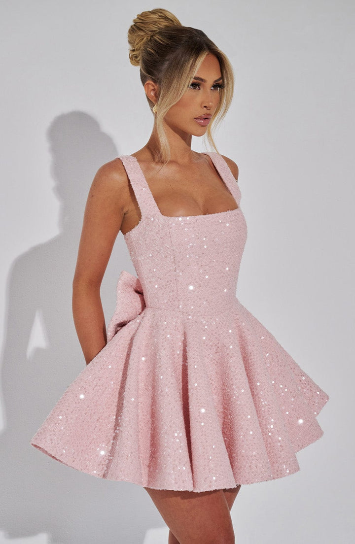 Elegant white sequin A-line mini dress for women, featuring a stunning backless design and chic bow.