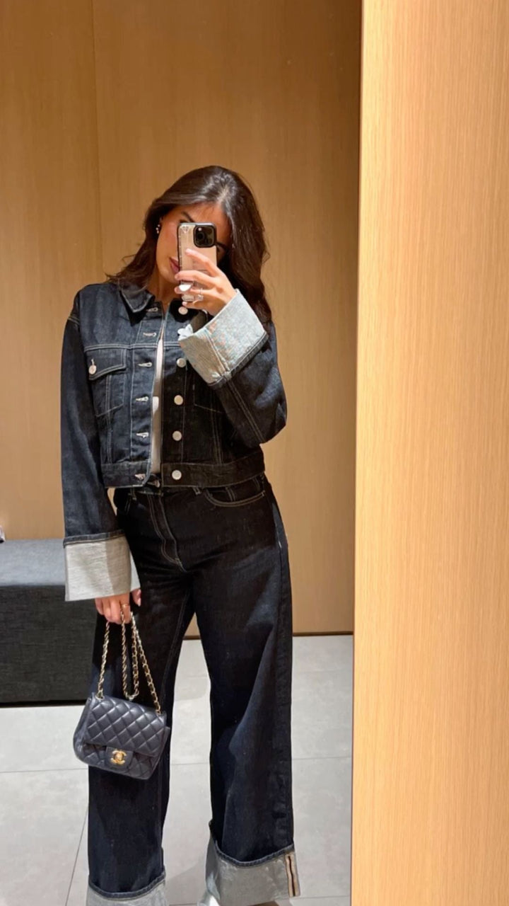 Close-up of the denim fabric on the women's cropped jacket and pants set