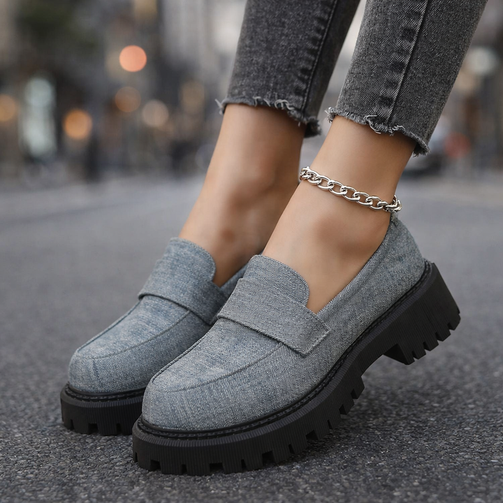 Close-up of women's denim platform loafers, showing texture and stylish, comfortable design