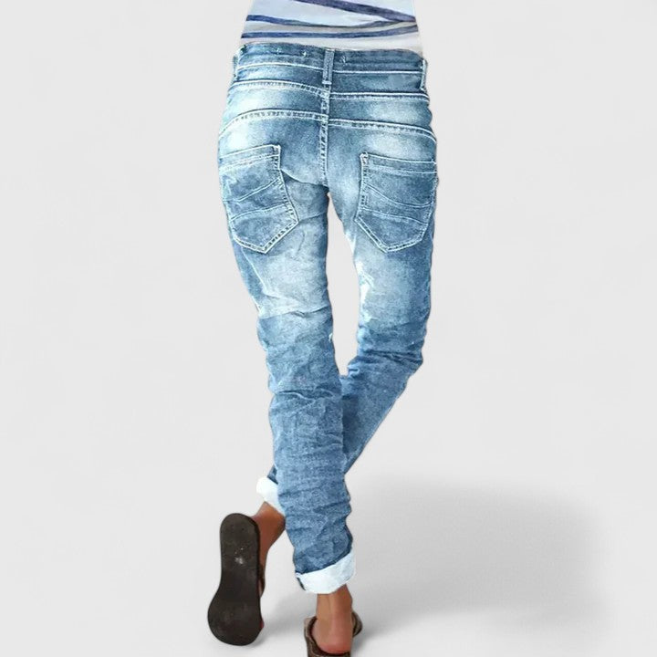 Mid-rise women's wide leg denim jeans with stylish distressed details & cuffed hem for a vintage look.