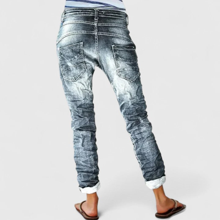 Relaxed fit women's distressed wide leg jeans, ideal for casual vintage style. Trendy denim apparel.