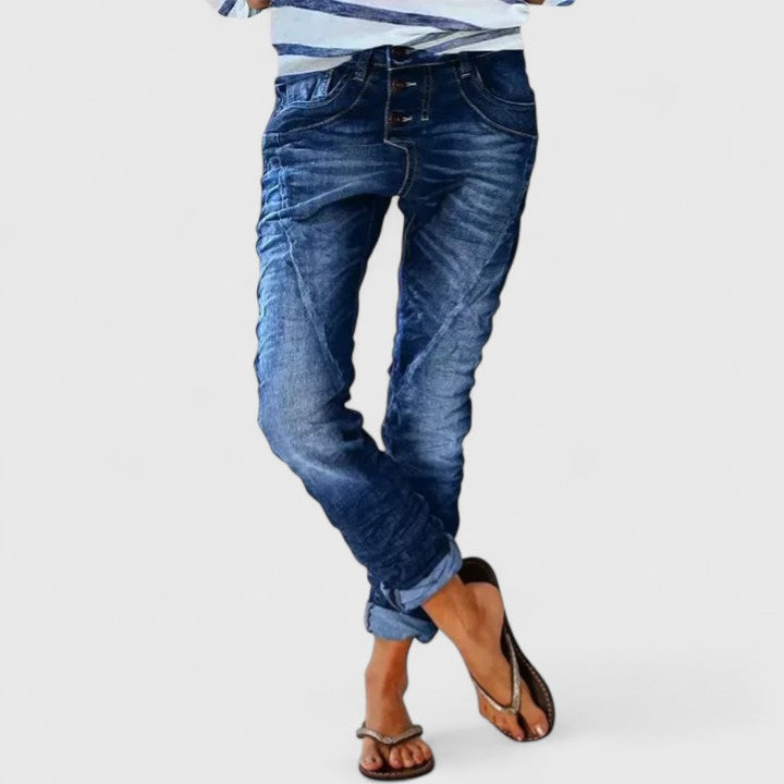 Stylish women's wide leg jeans with distressed details, relaxed fit, cuffed hem, & vintage denim appeal.
