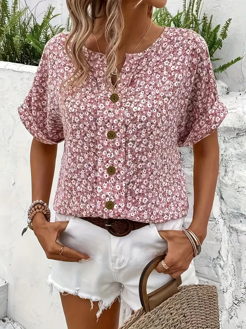 Stylish women's short sleeve summer top featuring a delicate ditsy floral print and button-front design.
