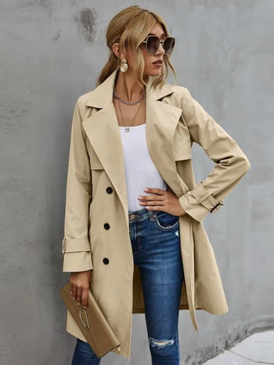 Women's double-breasted khaki trench coat with belt, showcasing classic elegant outerwear style