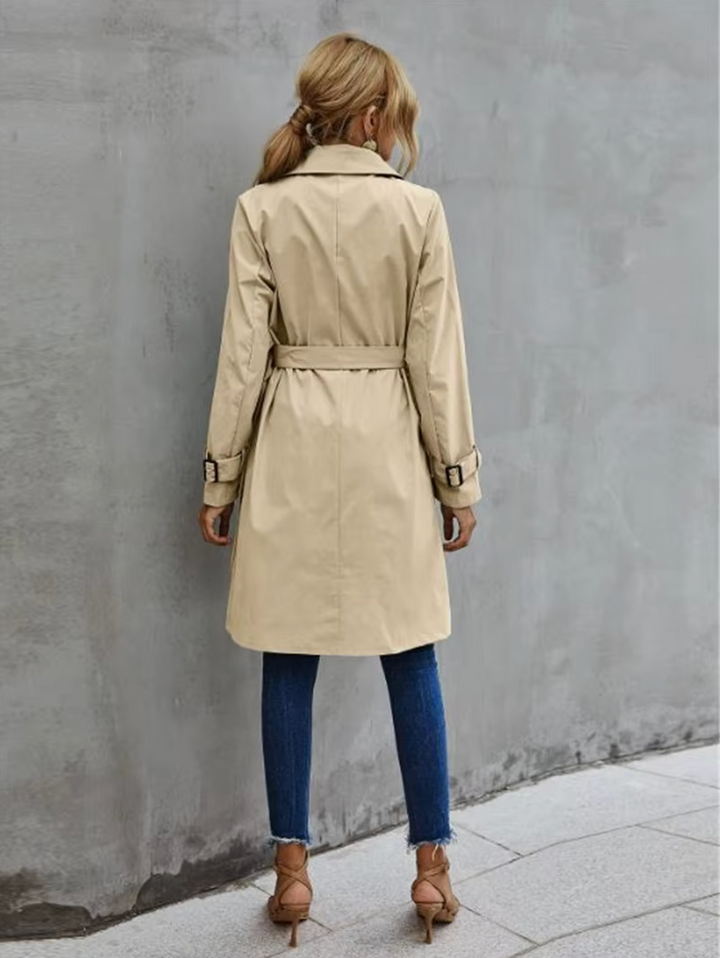 Stylish women's green belted trench coat, a timeless double-breasted all-season outerwear piece