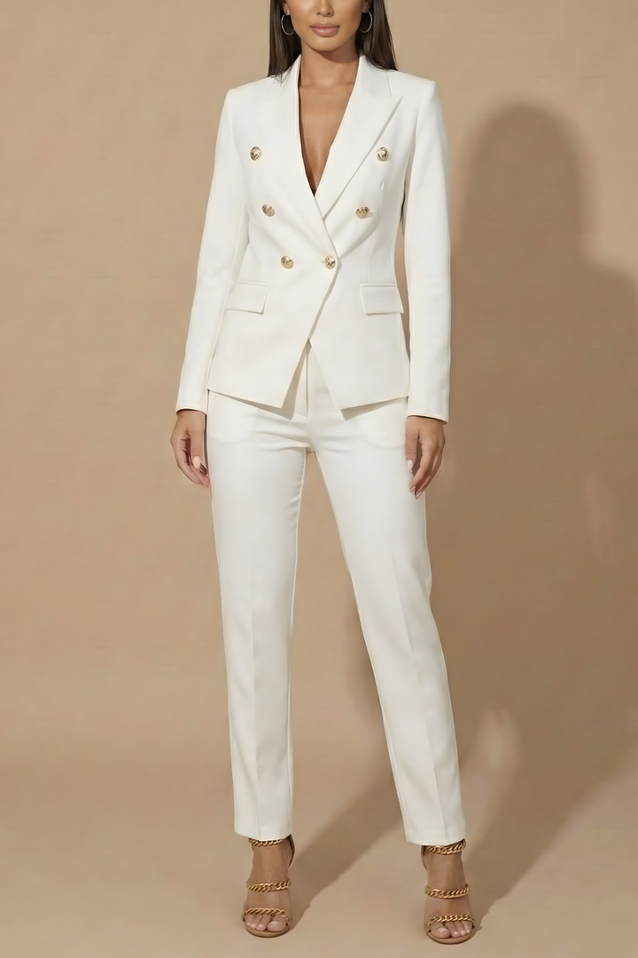 Chic women's double-breasted suit with gold buttons, pairing a blazer and tailored trousers.