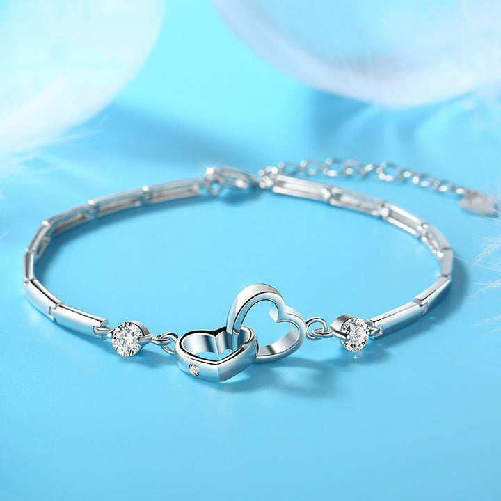 Women's double heart link bracelet in silver, adorned with sparkling crystals, a romantic accessory and perfect gift.