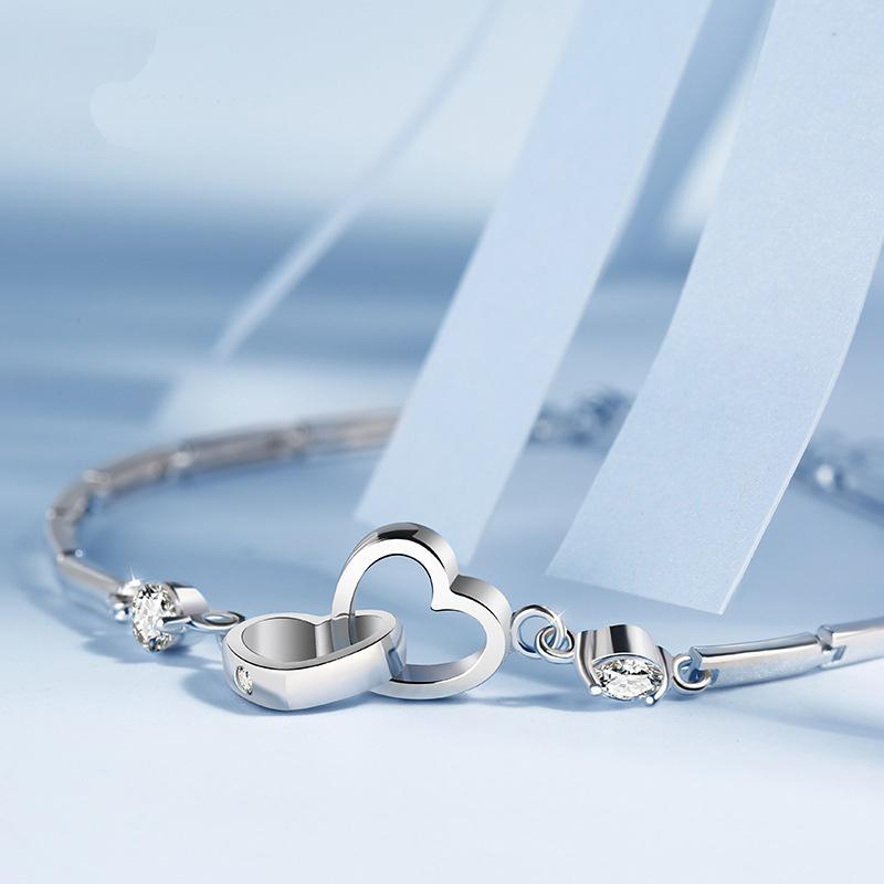 Elegant silver double heart bracelet with clear crystals, ideal jewelry gift for mother or daughter.