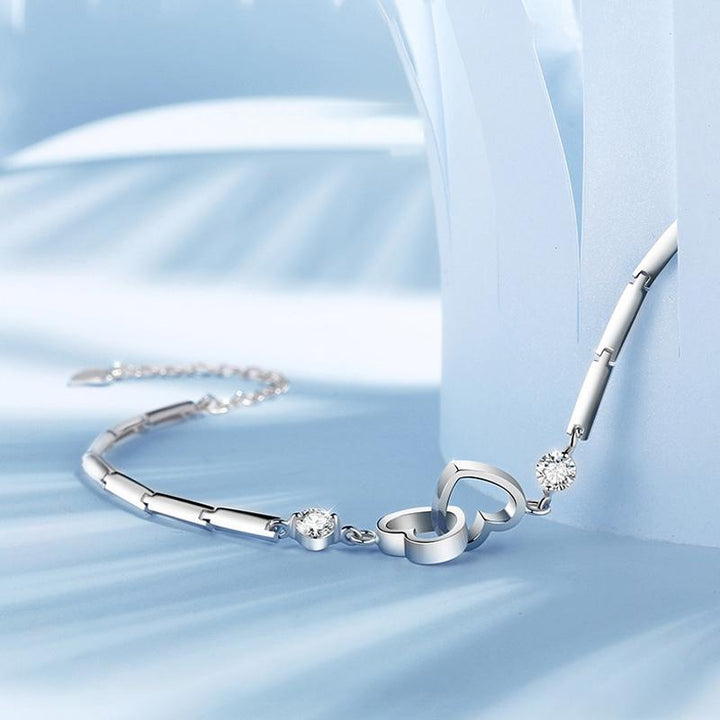 Stylish women's crystal heart link bracelet in polished silver, a lovely and versatile jewelry accessory.