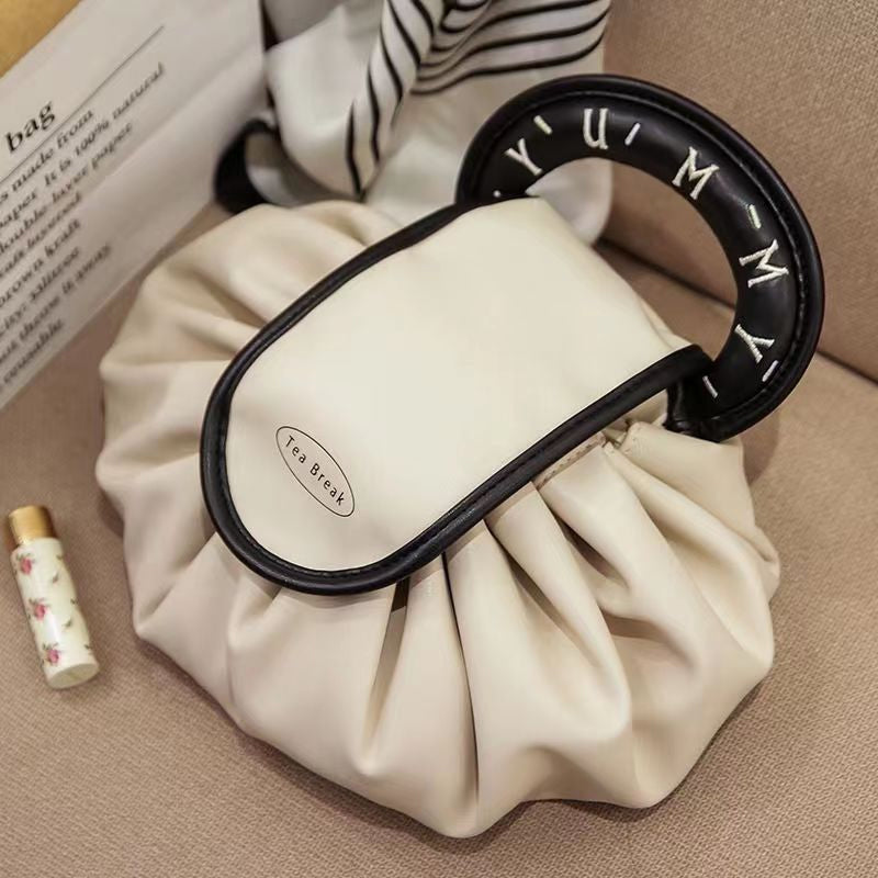 Makeup organizer handbag for women, showcasing its drawstring closure and durable fabric