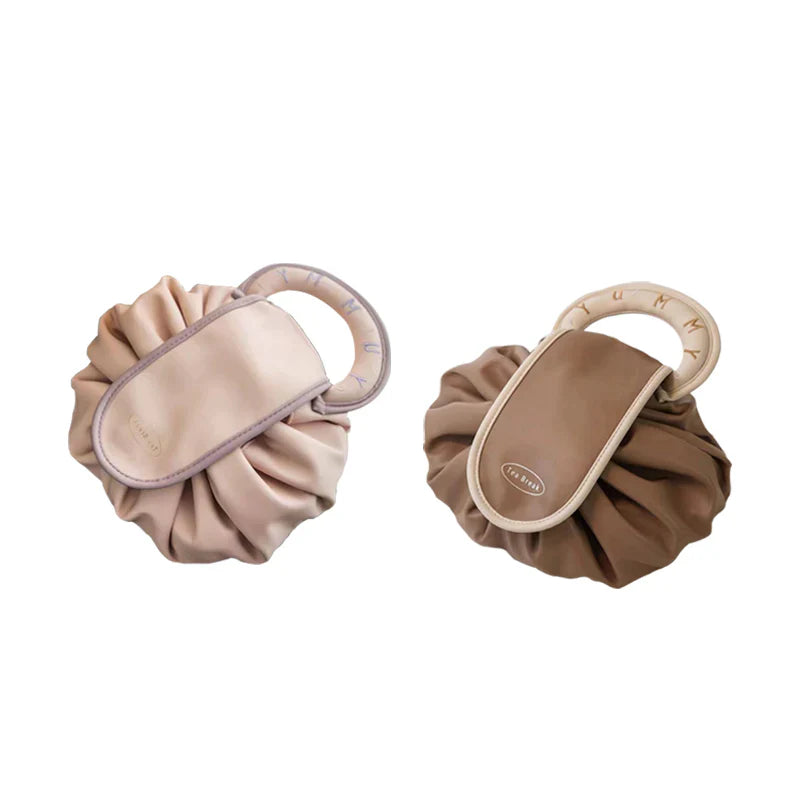 Women's drawstring makeup and travel organizer handbag, styled with other travel accessories