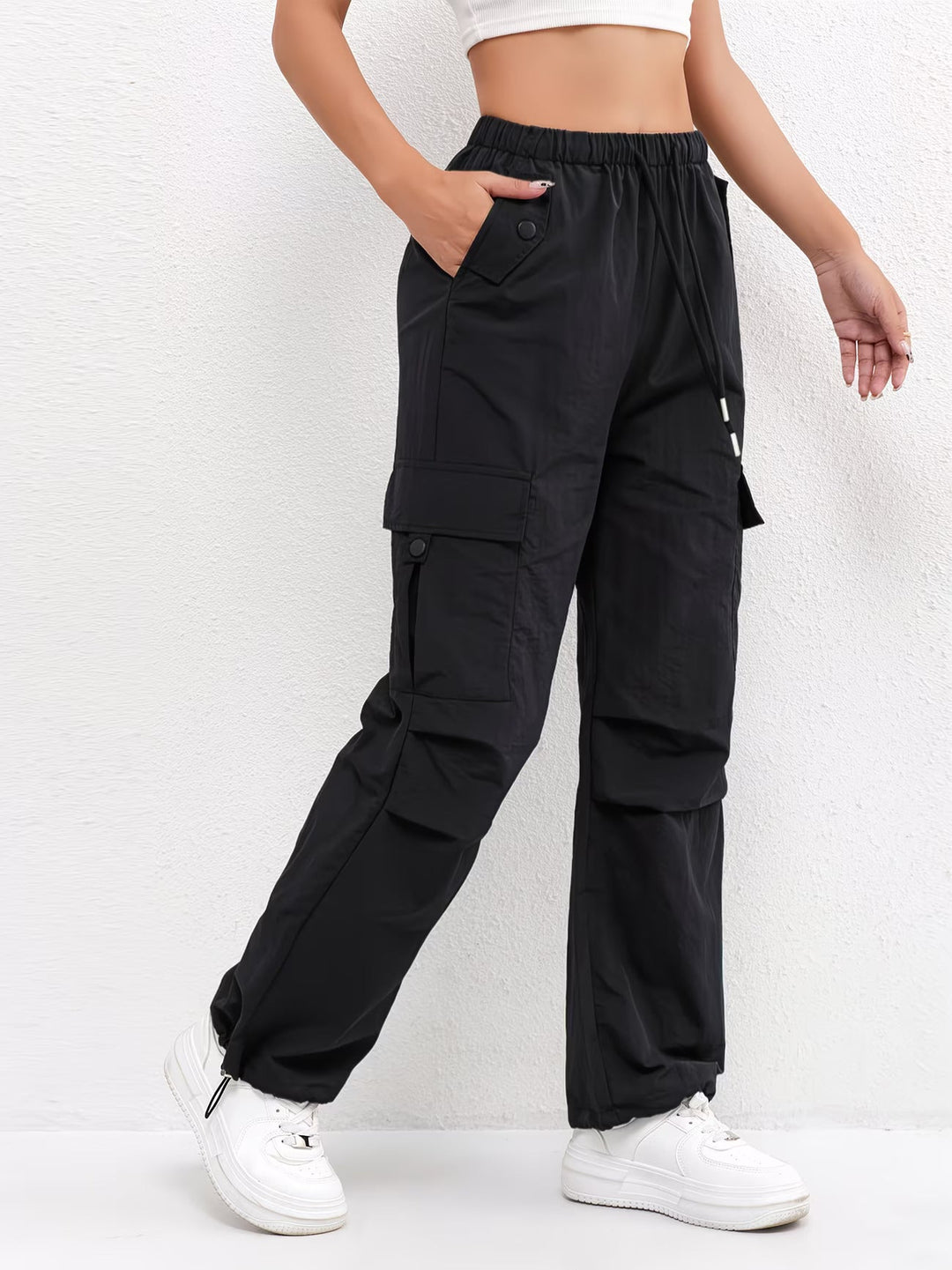 Trendy women's utility cargo parachute pants featuring a drawstring waist and adjustable hem, ideal for casual outfits.
