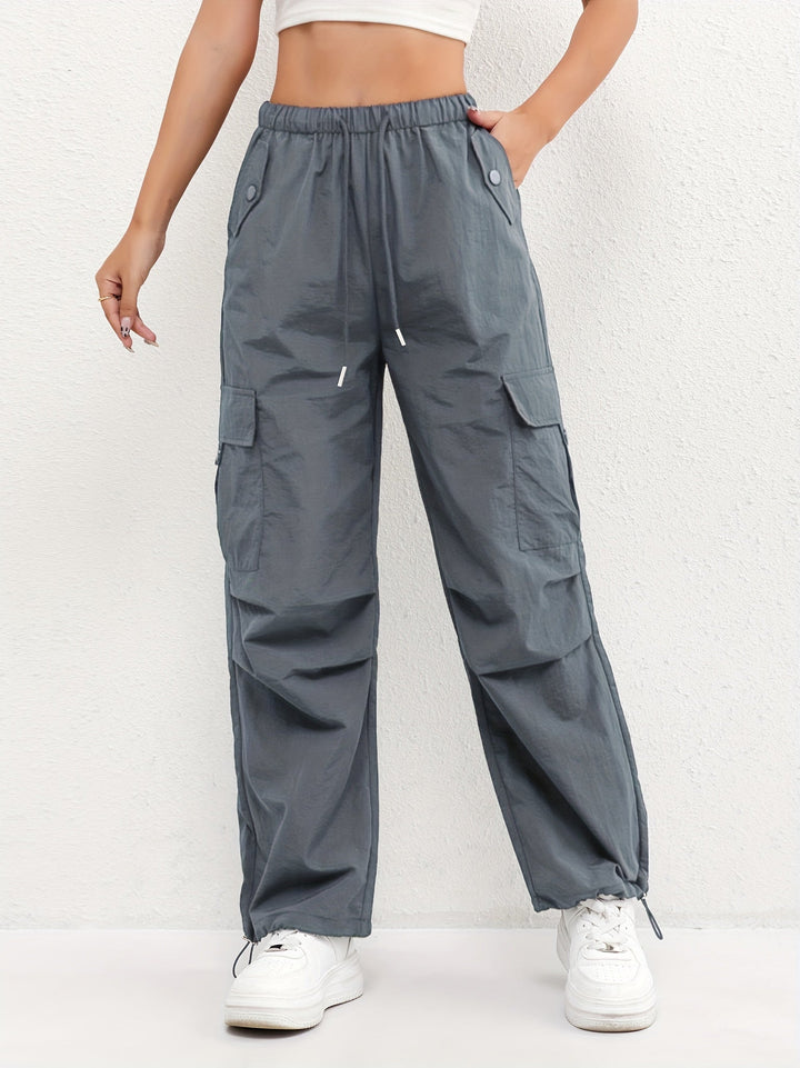 Relaxed fit women's parachute pants with a comfortable drawstring waist, embodying casual and chic street style fashion.