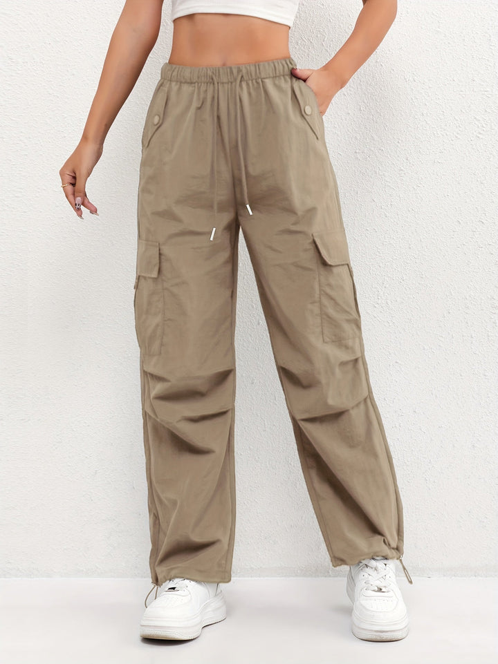 Women's street style parachute pants, designed with cargo pockets, a drawstring waist, and a modern relaxed fit.
