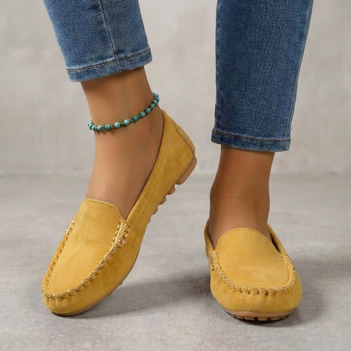 Women's driving moccasins with metallic accent, orthopedic sole, and comfortable slip-on design.