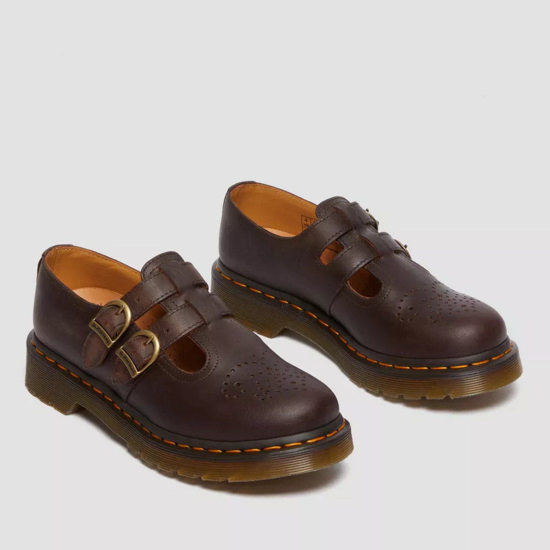 Pair of edgy women's double buckle Mary Jane flats, showcasing comfortable rounded toe & unique straps.