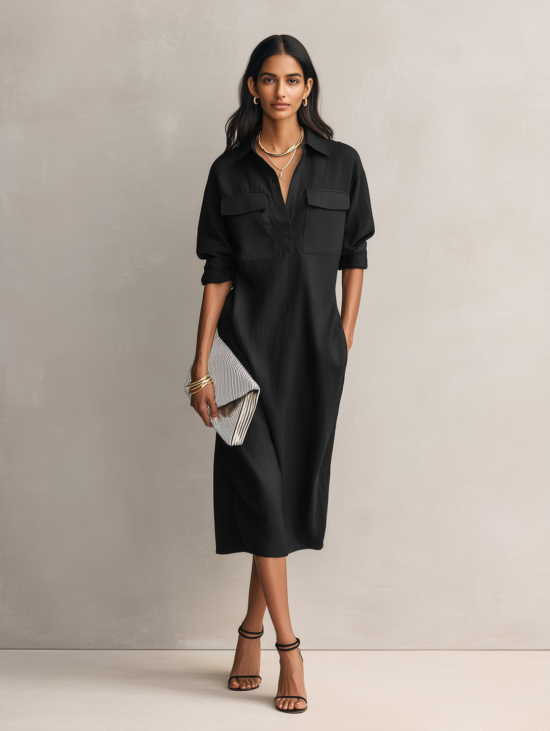 Relaxed fit women's black midi shirt dress, collared, featuring elbow sleeves. Ideal casual or elegant spring/summer fashion.