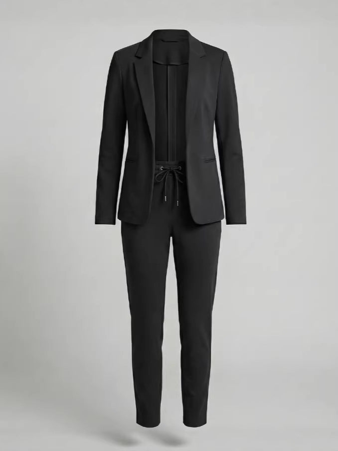 Model wearing a stylish women's two-piece suit set. Chic blazer & pants for versatile professional or casual wear.