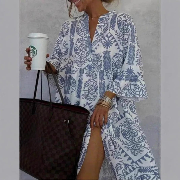 Casual women's midi dress with a vibrant floral print and tiered design, offering a chic boho summer look.