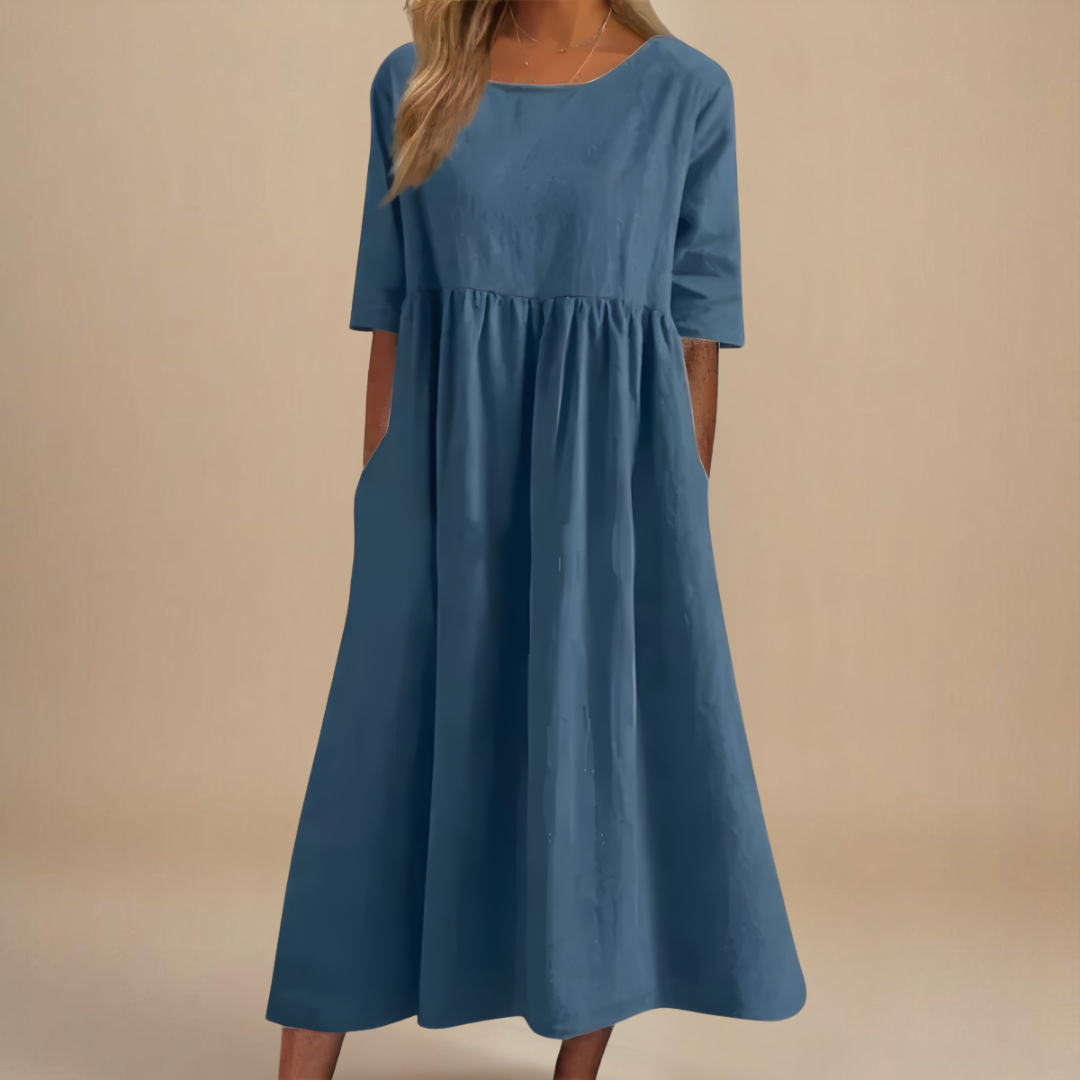 Casual women's half-sleeve midi dress with a chic gathered empire waist, scoop neck, and convenient pockets.