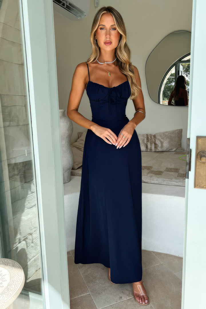 Close-up of fabric & cut on women's sleeveless A-line maxi dress, showcasing quality.