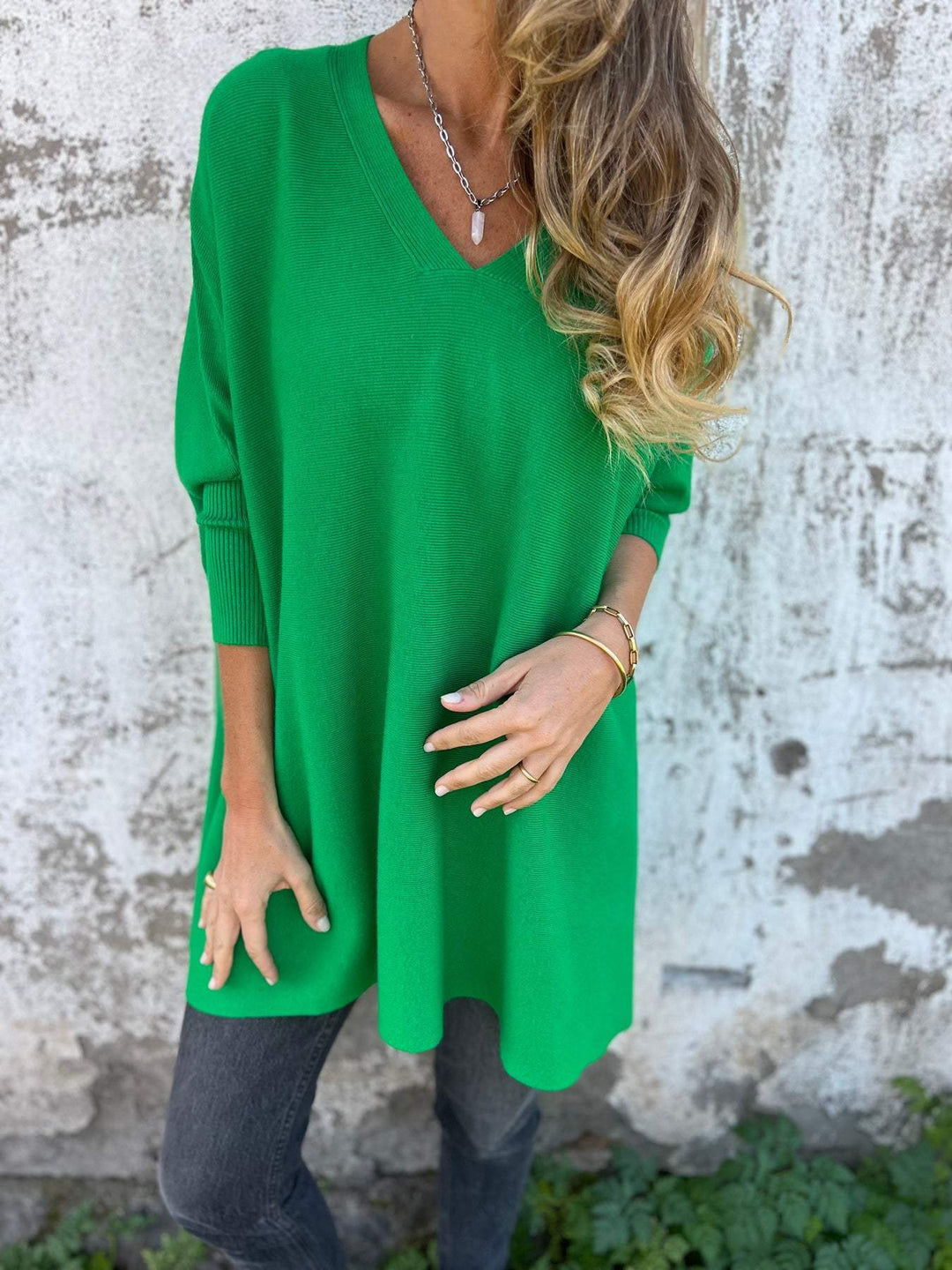 Front view of a women's relaxed fit V-neck swing tunic pullover sweater. Comfortable long sleeve casual top.