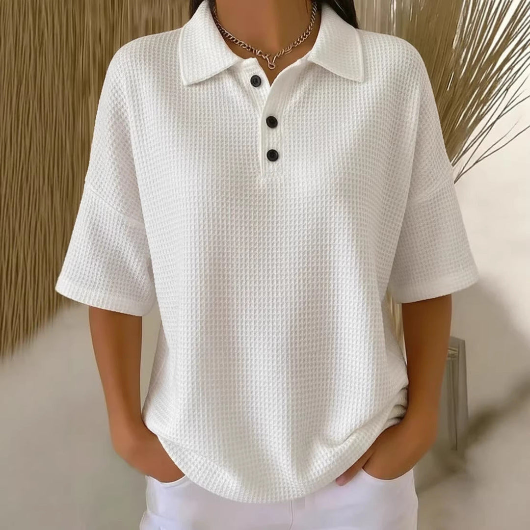 Relaxed fit women's short sleeve waffle knit polo blouse, button-up neck, perfect for casual comfort.