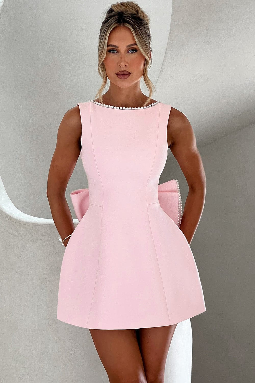 Women's elegant A-line mini dress with pearl trim, statement bow. Perfect for parties & special occasions.