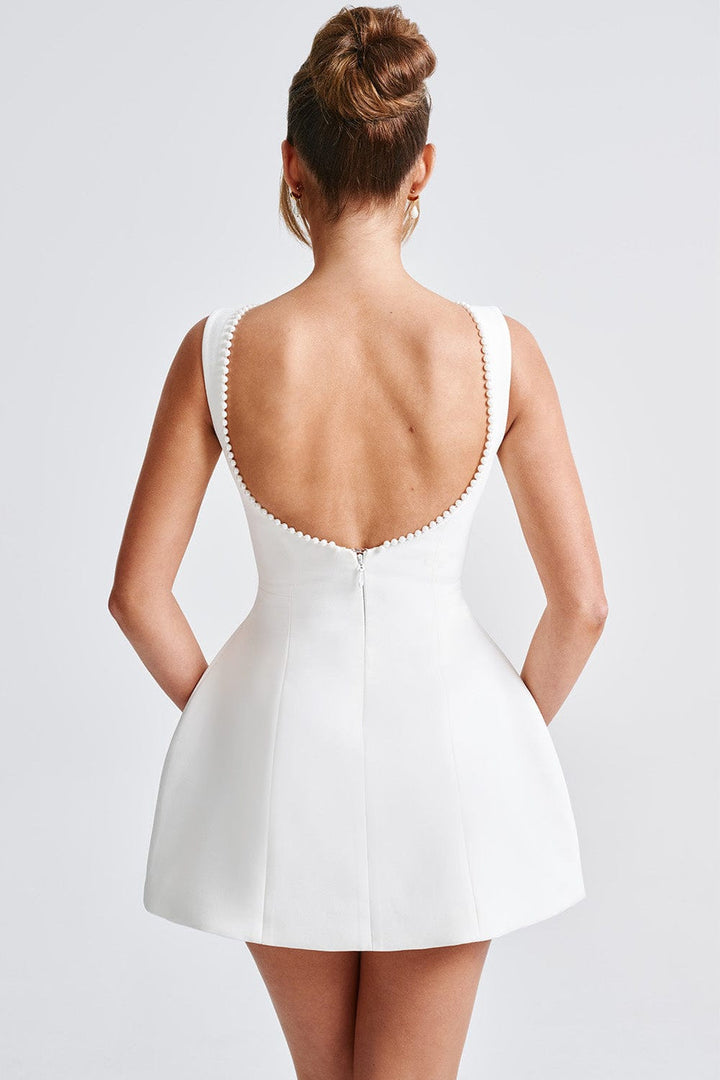 Chic women's cocktail party dress. Pearl-trimmed A-line mini with a stunning statement bow for special events.