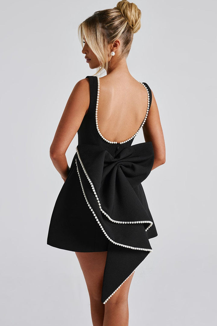 Sleeveless women's mini dress: A-line cut, sophisticated pearl trim, and a fashionable statement bow design.