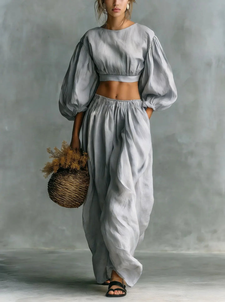 Stylish women's balloon sleeve top and wide-leg trouser set, an elegant two-piece outfit for summer vacations.
