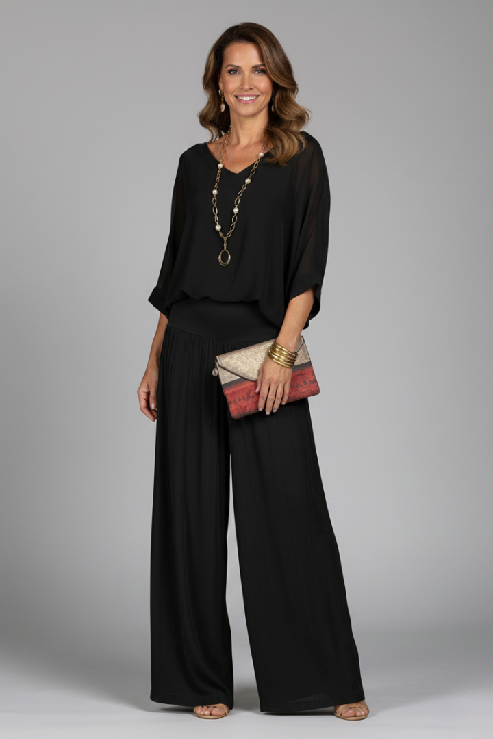 Full length view of a women's elegant batwing top & wide leg pant set, perfect for summer chic style.