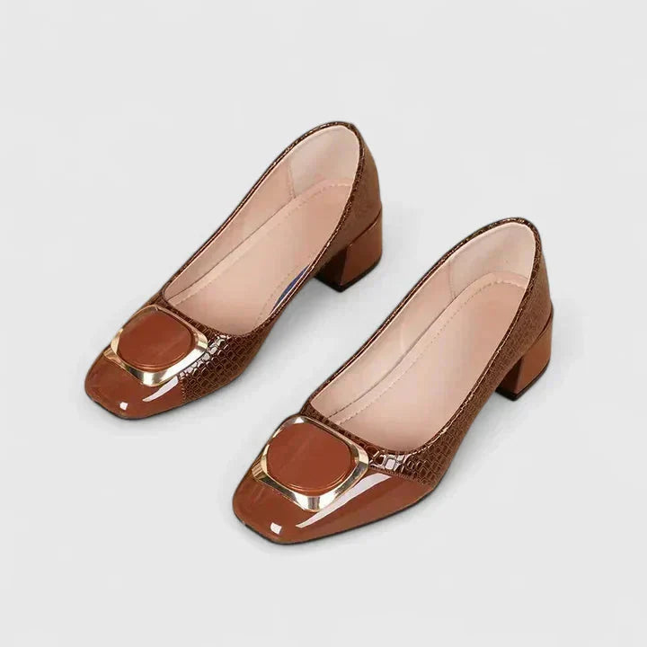 Women's fashionable block heel loafers with a bold gold buckle, offering both comfort and professional style.